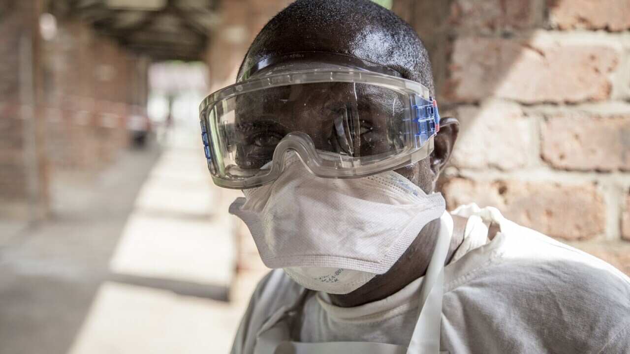 A health worker outside an isolation ward to diagnose and treat suspected Ebola patients.