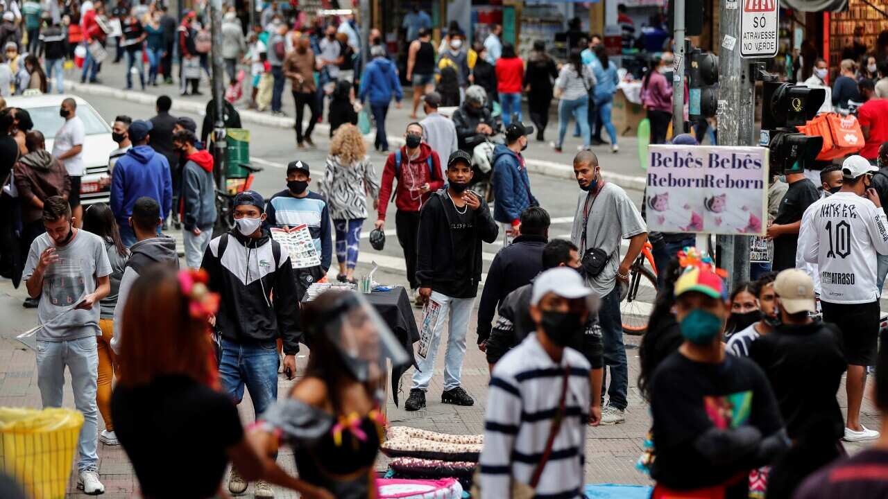 People walk through a popular shopping street in Sao Paulo, Brazil, 26 June 2020.