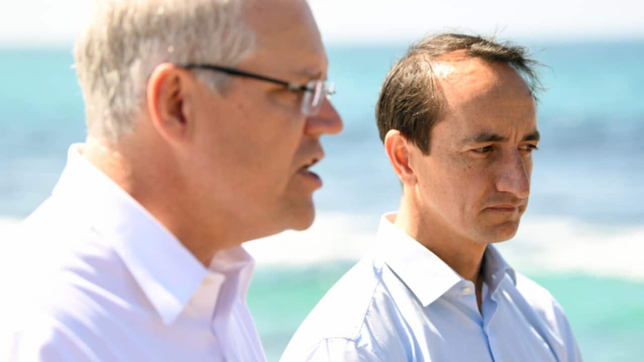 Prime Minister Scott Morrison (left) and Liberal Party candidate for Wentworth Dave Sharma speak to the media during a visit Bronte Beach in Sydney, Friday, September 14, 2018. (AAP Image/Joel Carrett) NO ARCHIVING