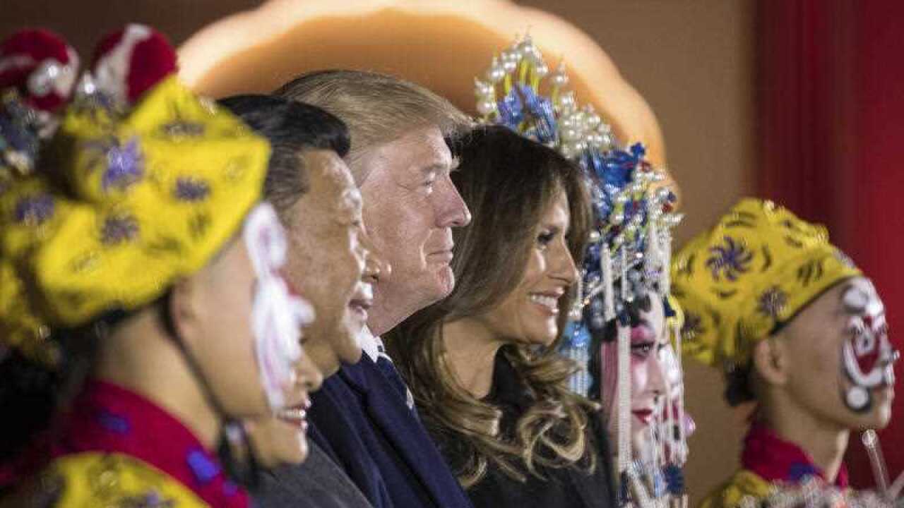 President Donald Trump, center, and first lady Melania Trump, center right, pose for a photograph with Chinese President Xi Jinping, center left