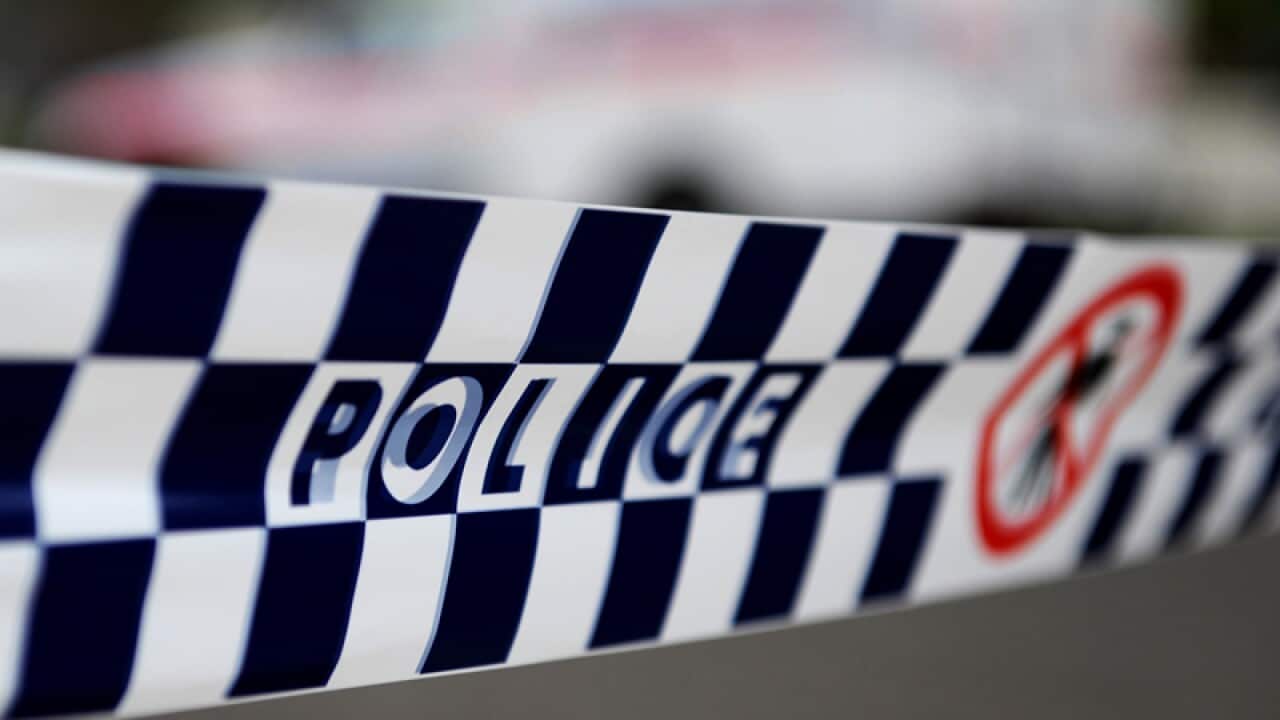 Police tape restricts access to a street