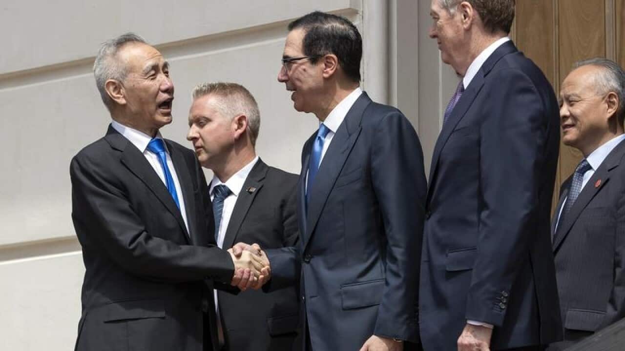 Liu He (L) and Steven Mnuchin (C)