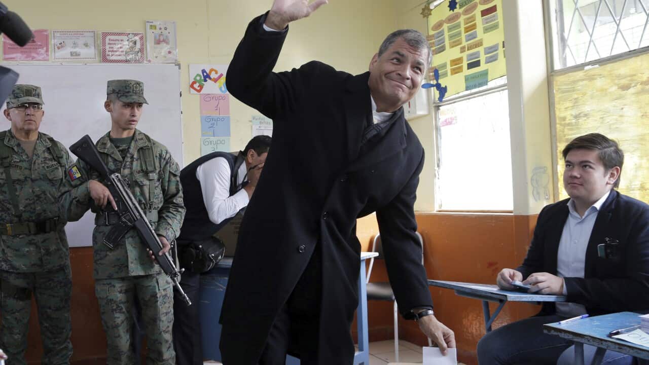 Ecuador's President Rafael Correa drops his ballot during the general elections Quito, Ecuador, Sunday, April 2, 2017.