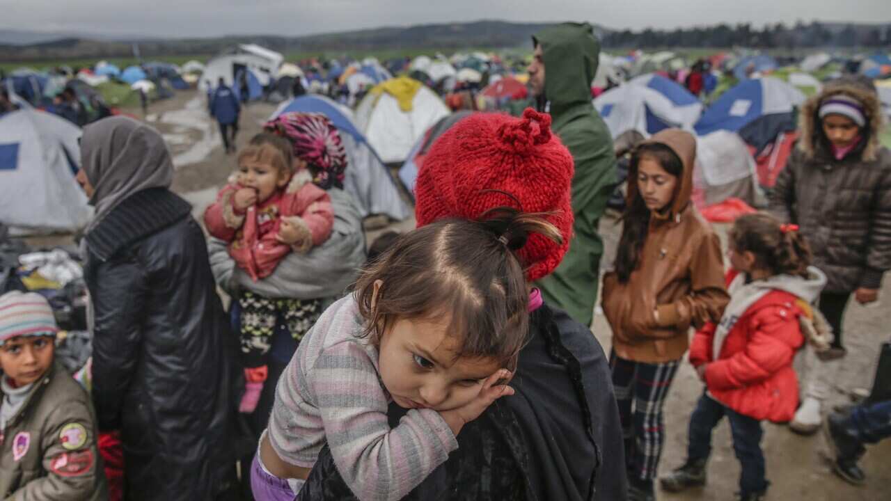 Refugees queue at the Greek-Macedonian border near Idomeni, northern Greece, 09 March 2016.