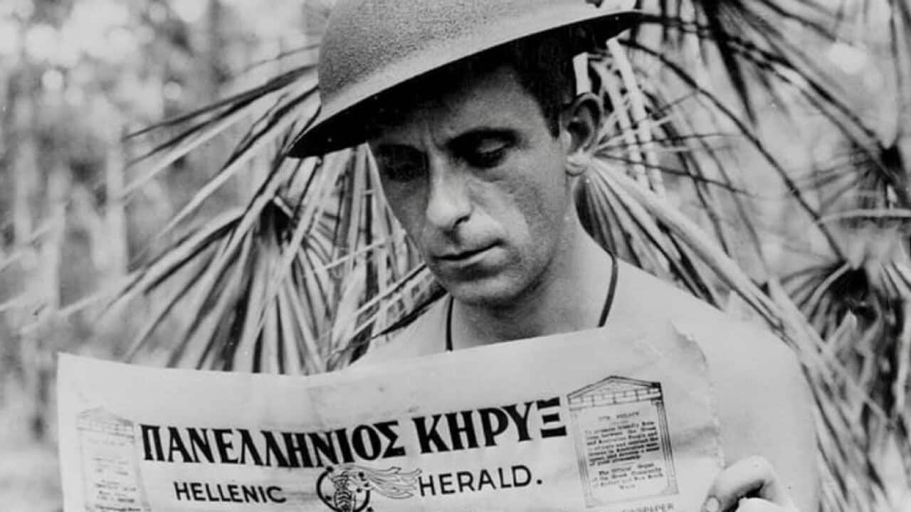 Xenophon Castrisos (Castles), an aerial photographer with the Royal Australian Air Force, reads the Hellenic Herald, a Greek-Australian newspaper..jpg
