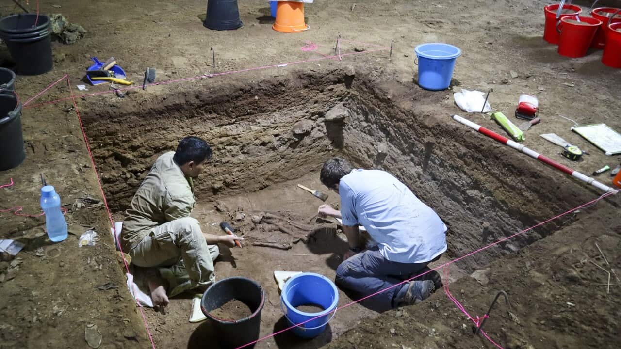 Dr Tim Maloney and Andika Priyatno work at the site in a cave in East Kalimantan, Borneo (AAP).