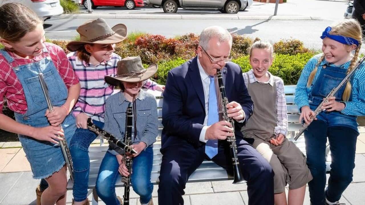 Scott Morrison plays a clarinet with students in Albury in September.