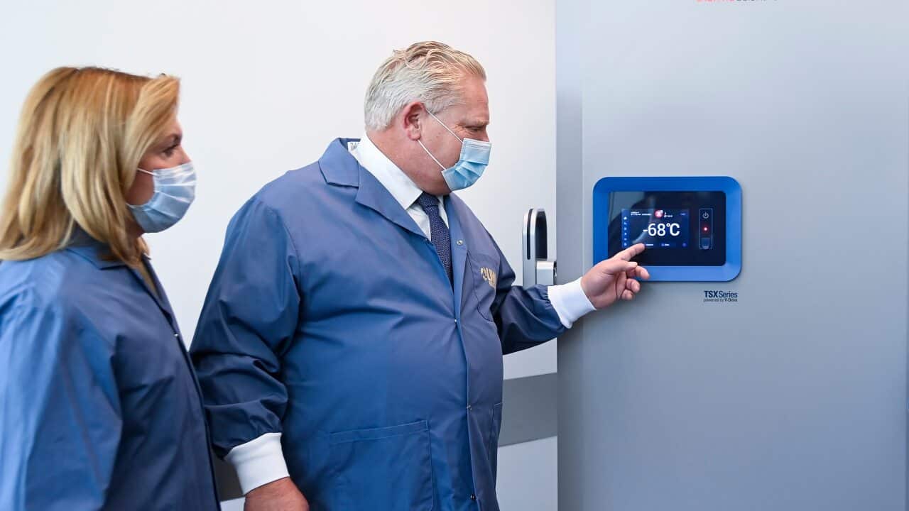 Ontario Premier Doug Ford and Ontario Health Minister Christine Elliott look at freezers ahead of COVID-19 vaccine distribution in Toronto.