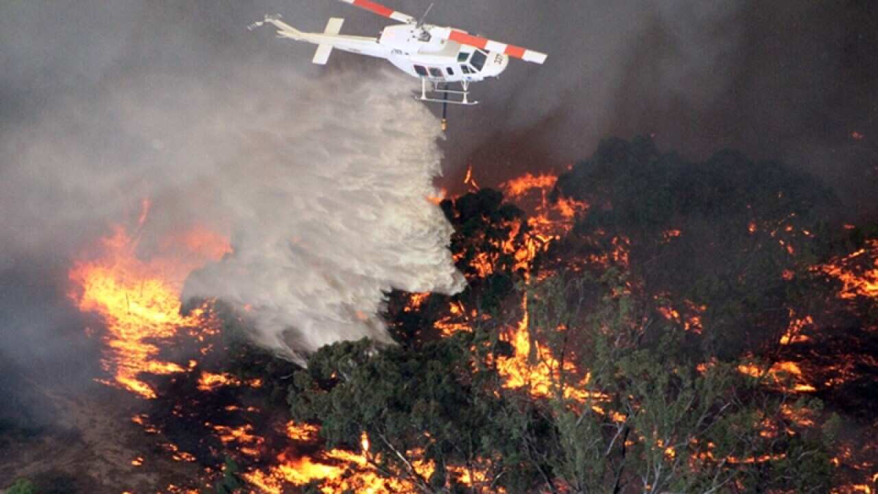 A fire is doused by a helicopter in Victoria's Grampians region