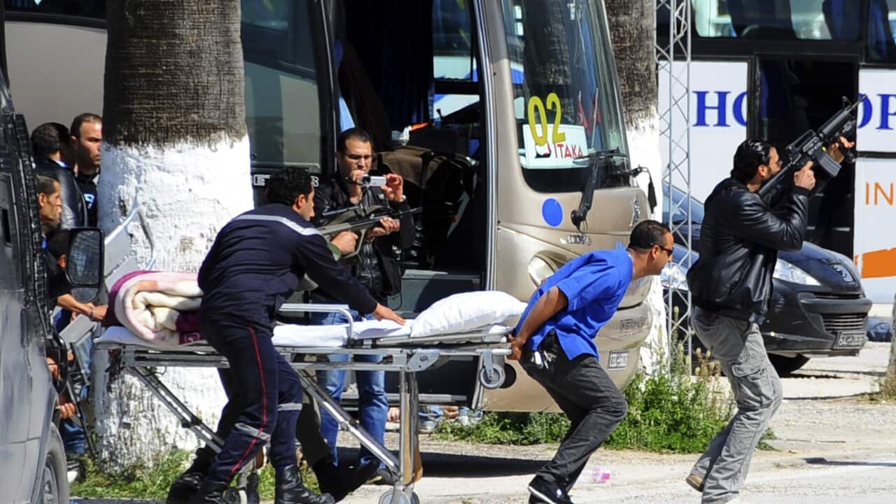 Escorted by security forces, rescue workers pull an empty stretcher outside the Bardo museum Wednesday, March 18, 2015 in Tunis, Tunisia. (AP Photo/Salah Ben Mahmoud)