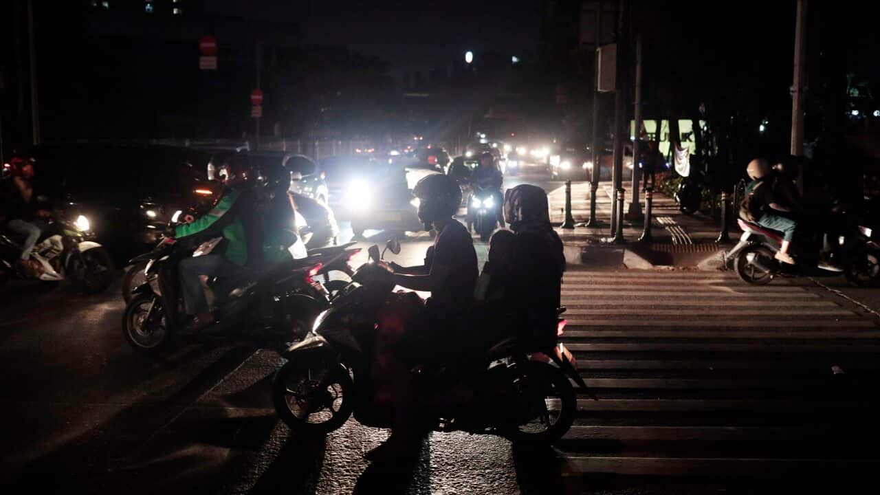 Motorists navigate through traffic during a power outage in Jakarta, Indonesia.