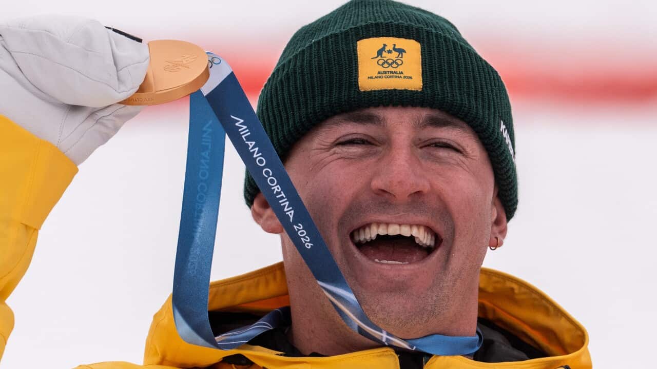 Cooper Woods holding gold medal.
