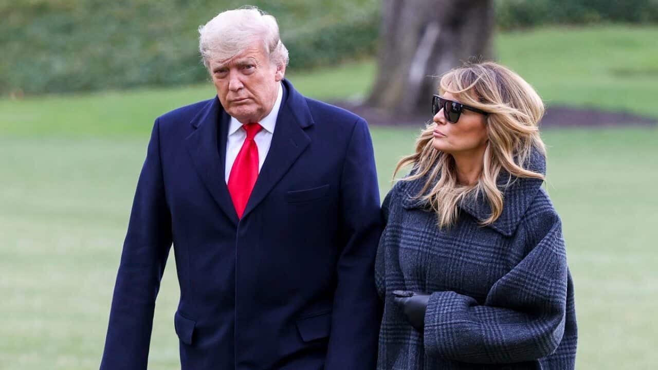 US President Donald Trump and First Lady Melania Trump walk on the South Lawn