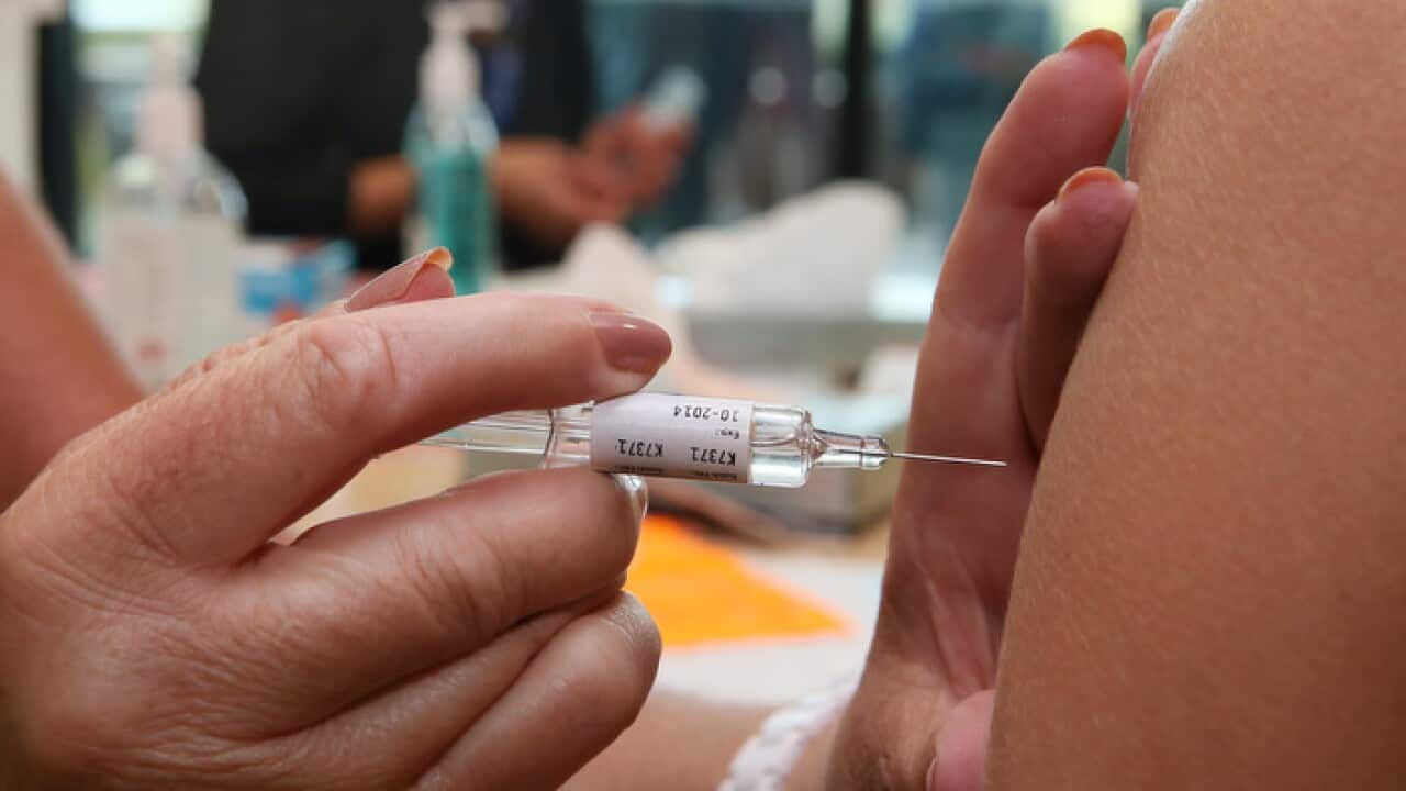 Health care workers receive the flu vaccination injection at the Royal Children's Hospital in Melbourne, Tuesday, March 4, 2014. (AAP Image/David Crosling) NO ARCHIVING