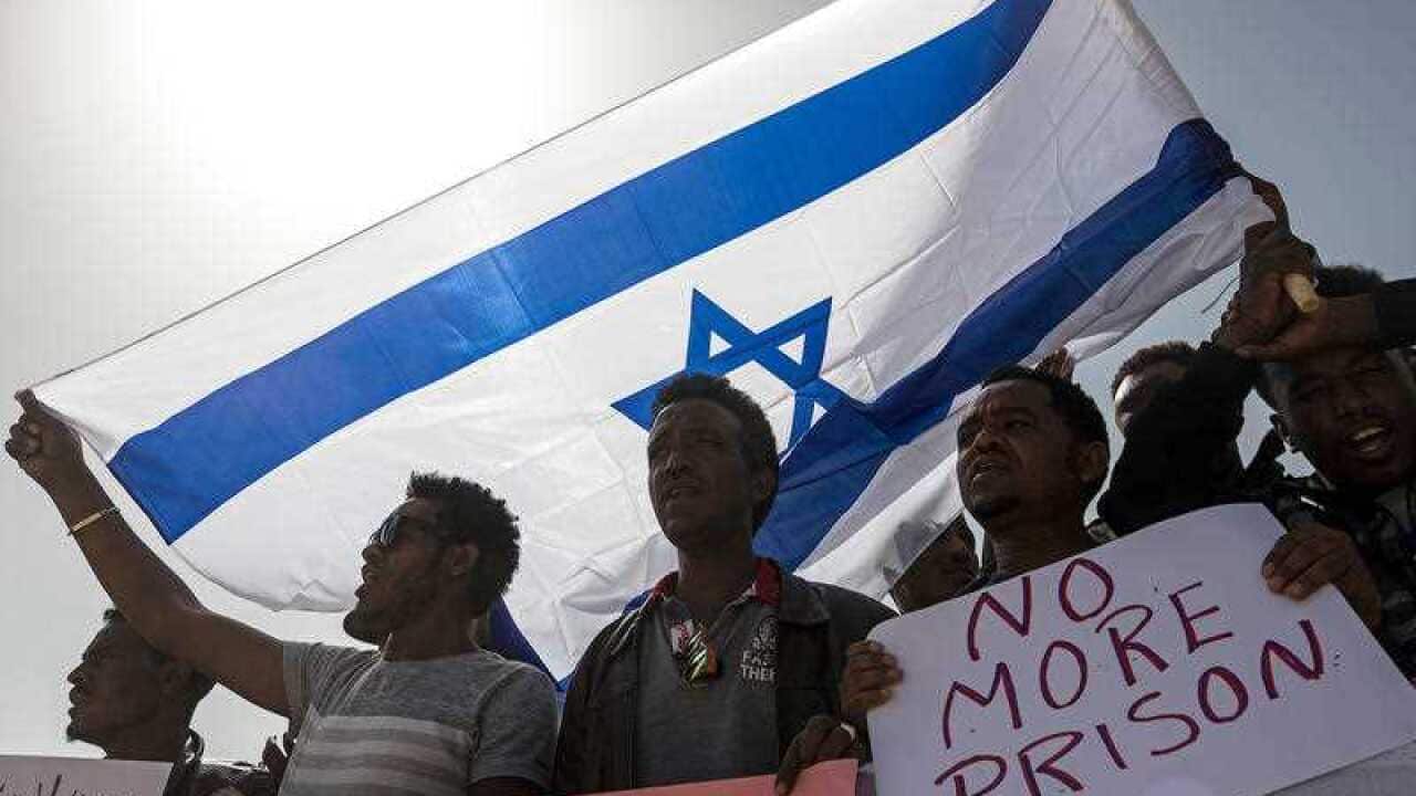Asylum seekers march during a protest outside Israeli Prison Saharonim, in the Negev desert, southern Israel.