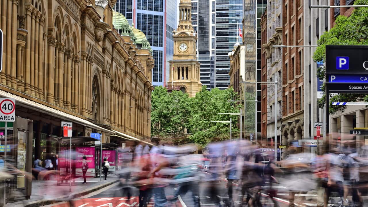 People crowd crossing street in central Sydney