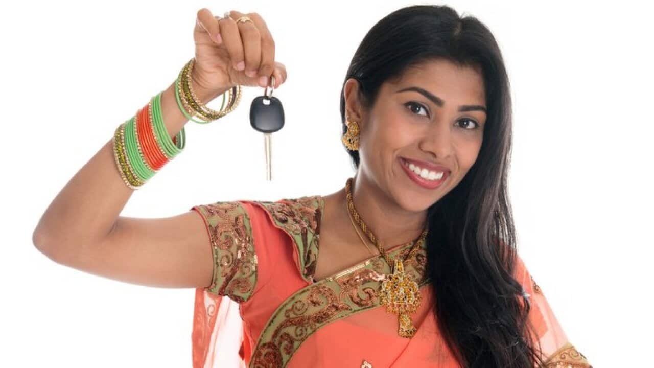 Indian woman holding car key