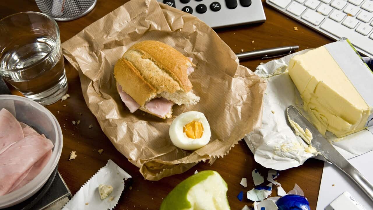 An office desk cluttered with food