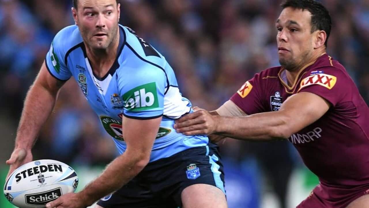 NSW Origin captain Boyd Cordner (L) is tackled by Will Chambers