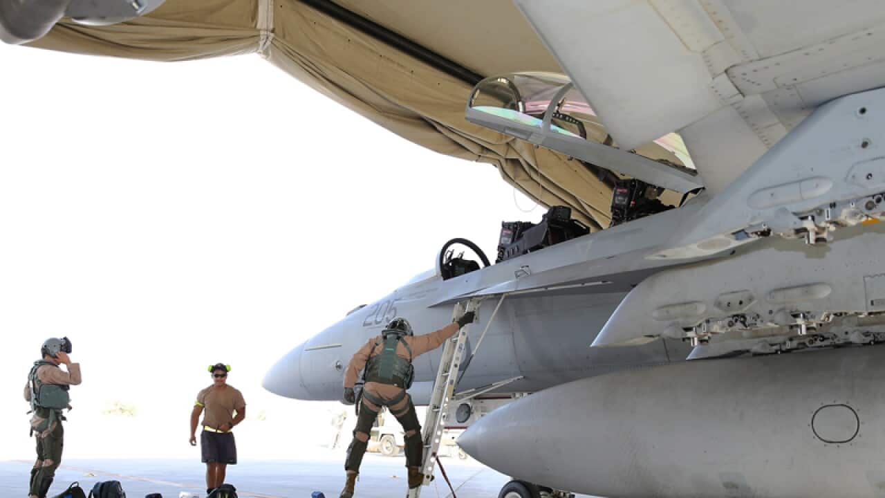 RAAF aircrews disembark from a RAAF F/A-18F Super Hornet