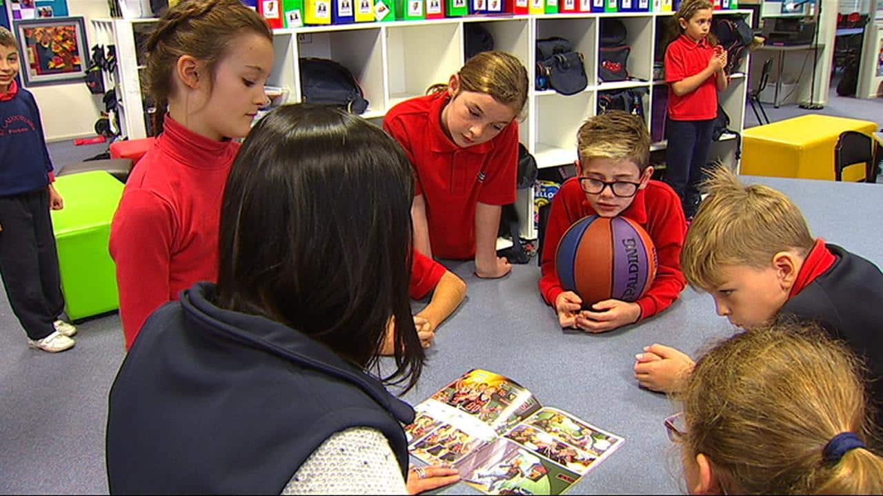 Jonty with friends reading the comic.