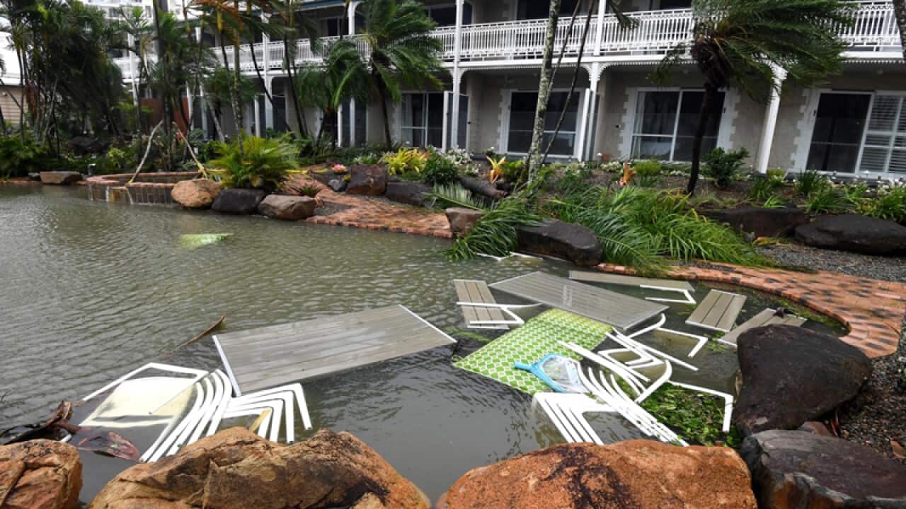 Outdoor furniture are sunk in a motel pool for safety at Airlie Beach