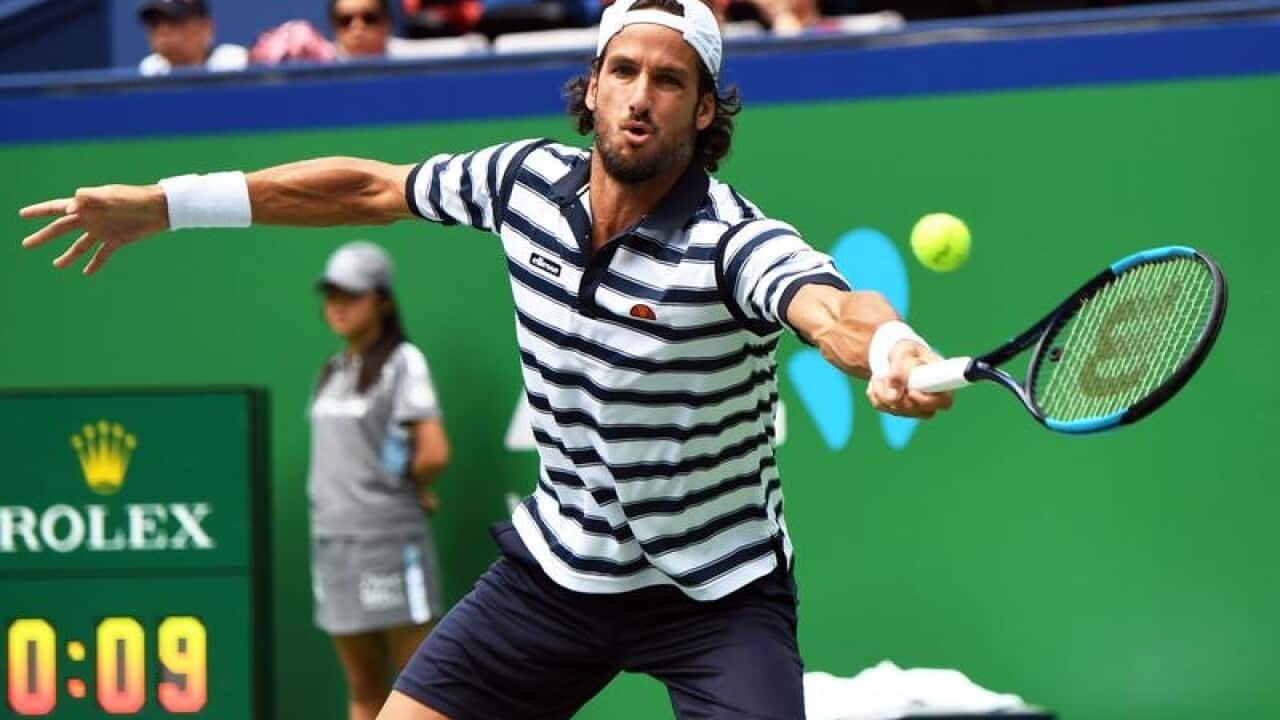 Feliciano Lopez of Spain returns a shot