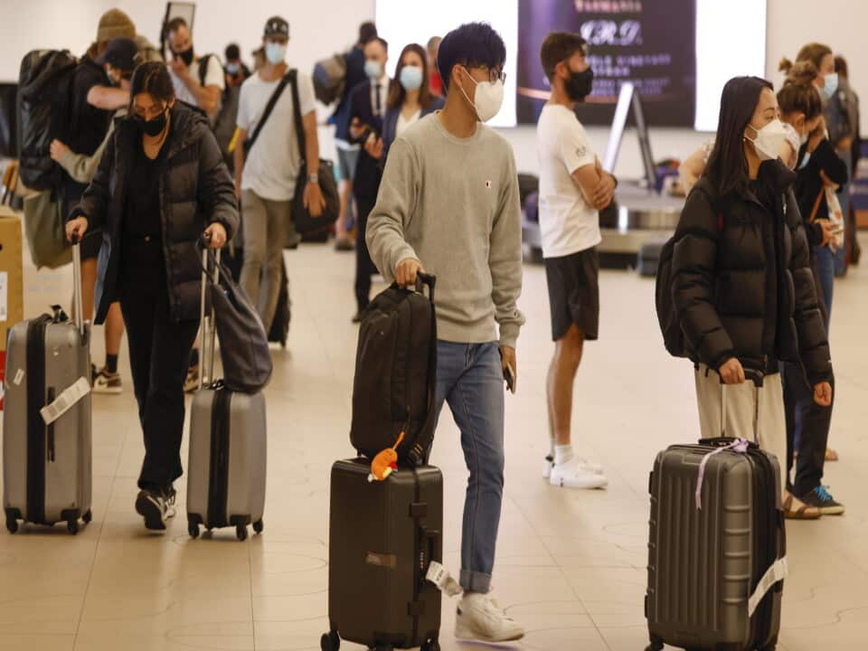 People arrive at Hobart Airport in Hobart, Wednesday, December 15, 2021. Tasmania has reopened to all fully-vaccinated travellers from mainland states and territories. (AAP Image/Rob Blakers) NO ARCHIVING