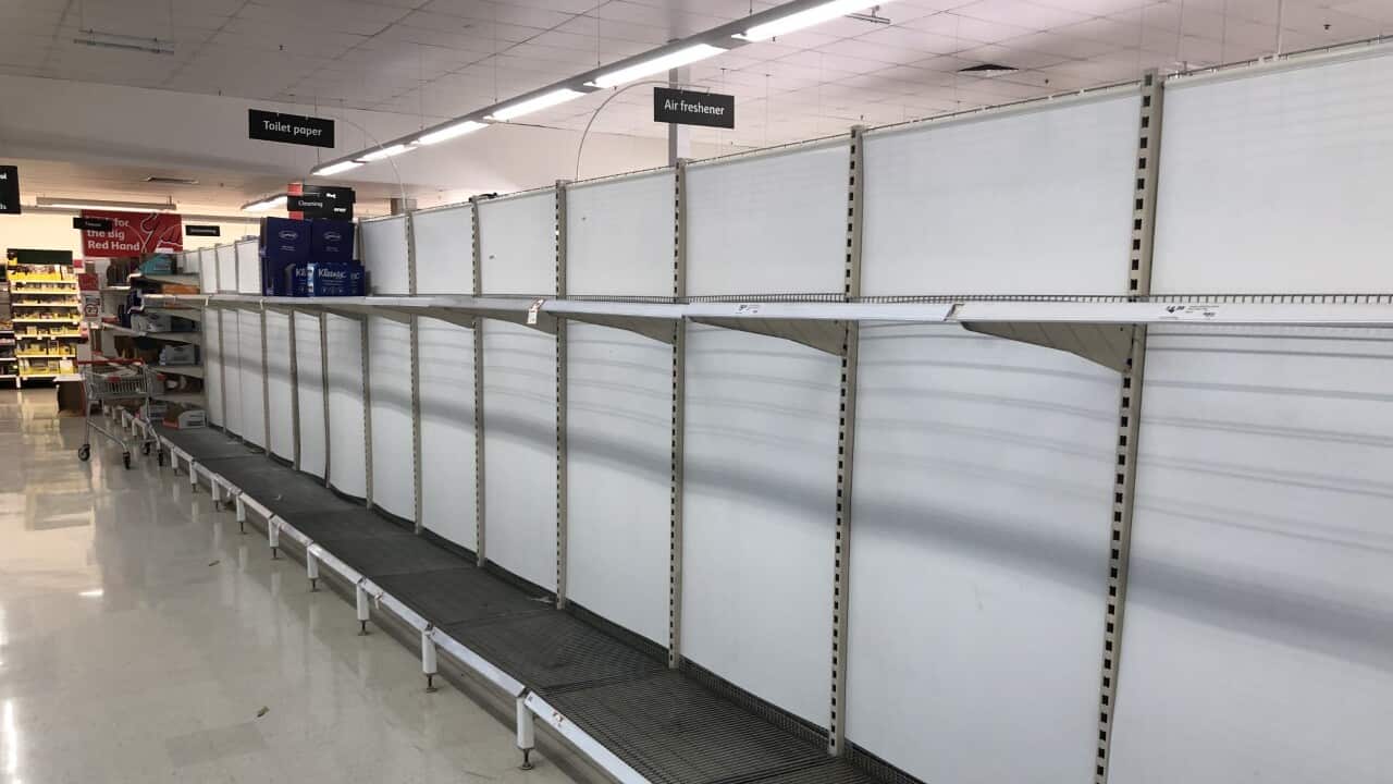 Empty toilet paper shelves at a Coles supermarket.