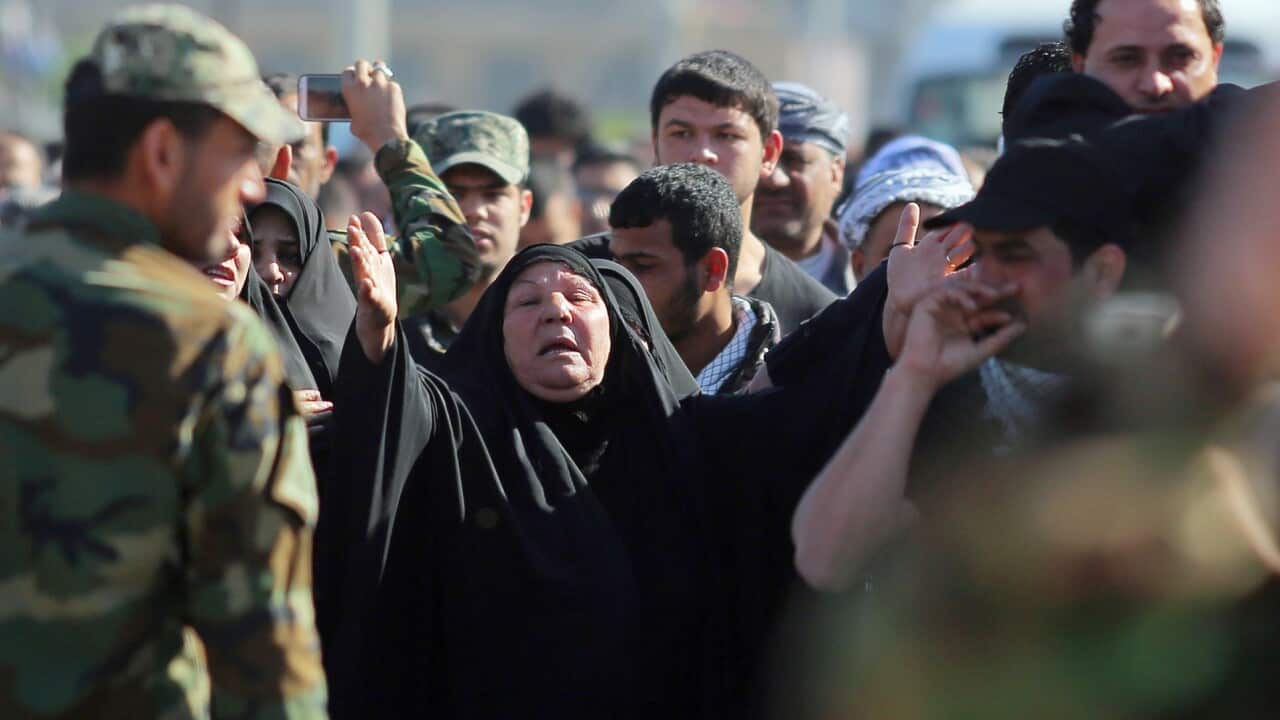 A woman grieves during the funeral procession for six members of the Shiite group, Asaib Ahl al-Haq, or League of the Righteous, killed in Tikrit fighting Islamic militants, in Najaf, 100 miles (160 kilometers) south of Baghdad, Iraq(AP Photo/Jaber al-Hel