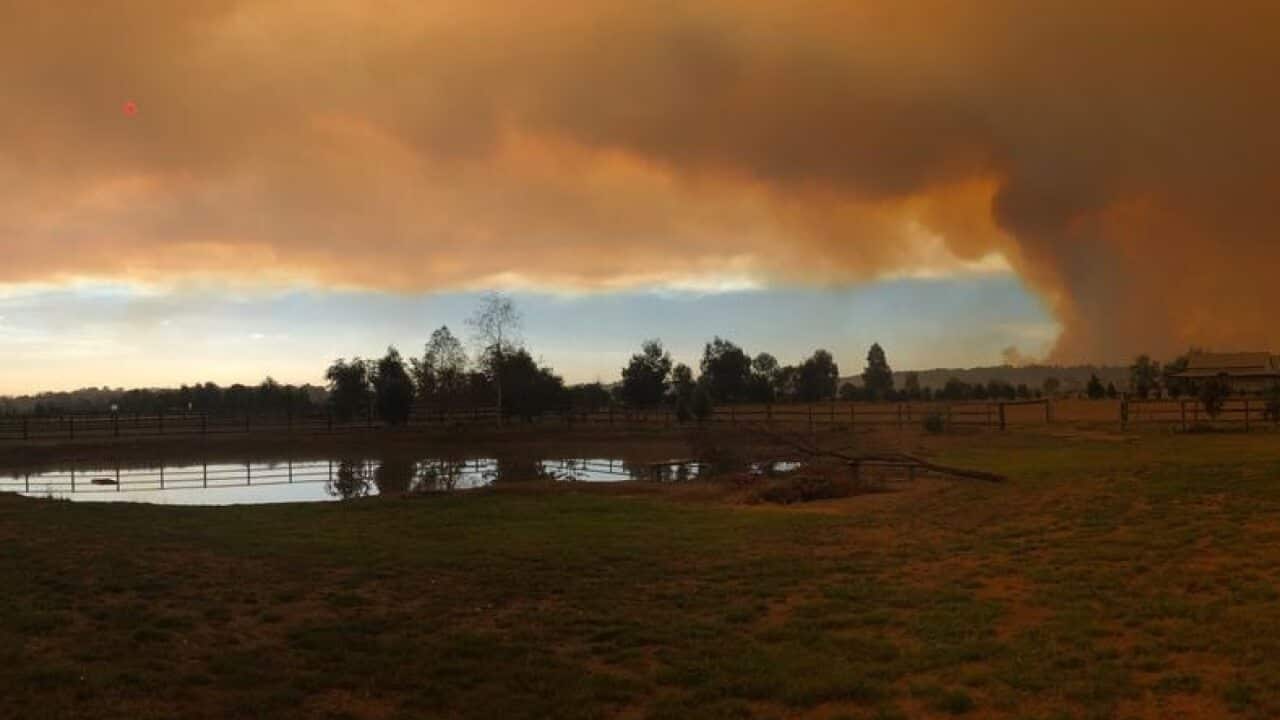Bushfire smoke fills the sky.