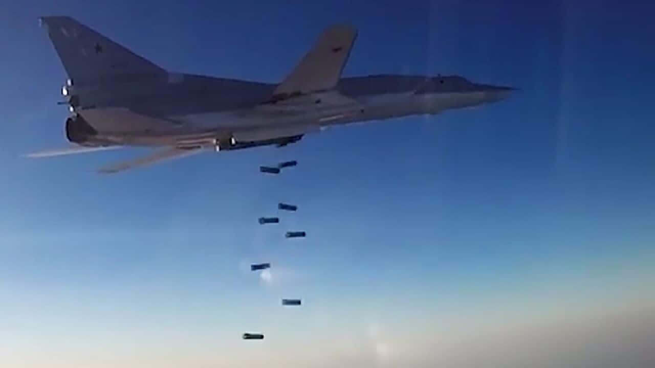 A Tu-22M3 long-range bomber releasing its payload above Syria
