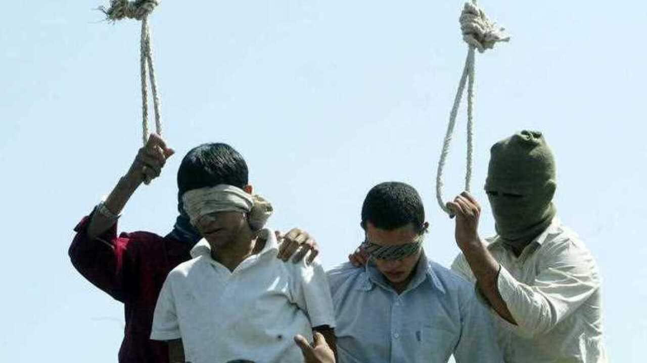 Blindfolded Mahmoud Asgari, 16, left, and another unidentified teenager are set to be publicly hanged, in Mashhad, Iran