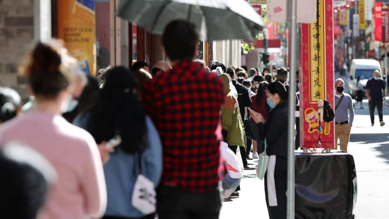 People are seen in a queue at the Russell Street testing clinic in Melbourne, Monday, December 20, 2021. Overwhelming testing demand has created long queues.