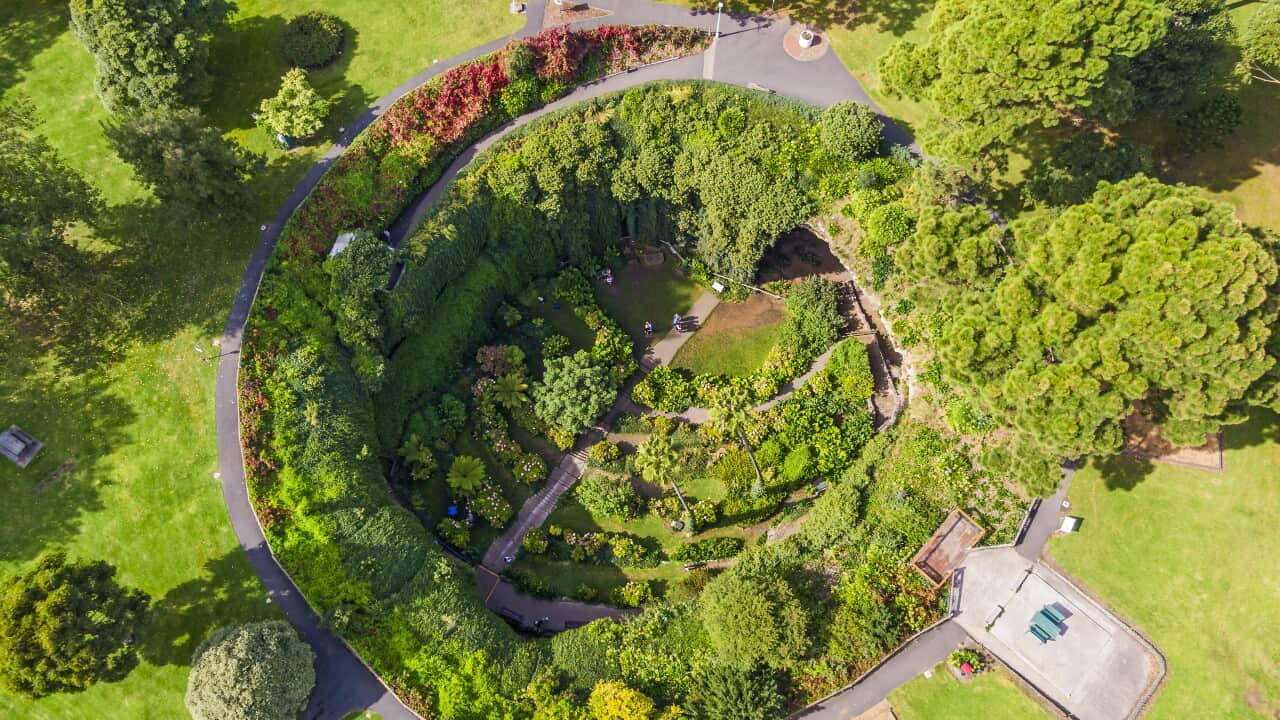 Aerial view Mount Gambier's Umpherston Cave sink hole with verdant green landscaped gardens