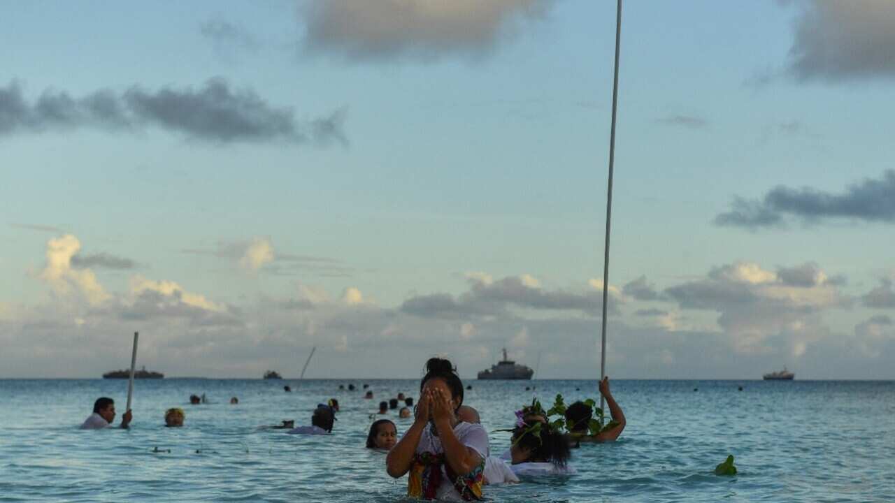Tuvalu resident stands in water (AAP).jpg