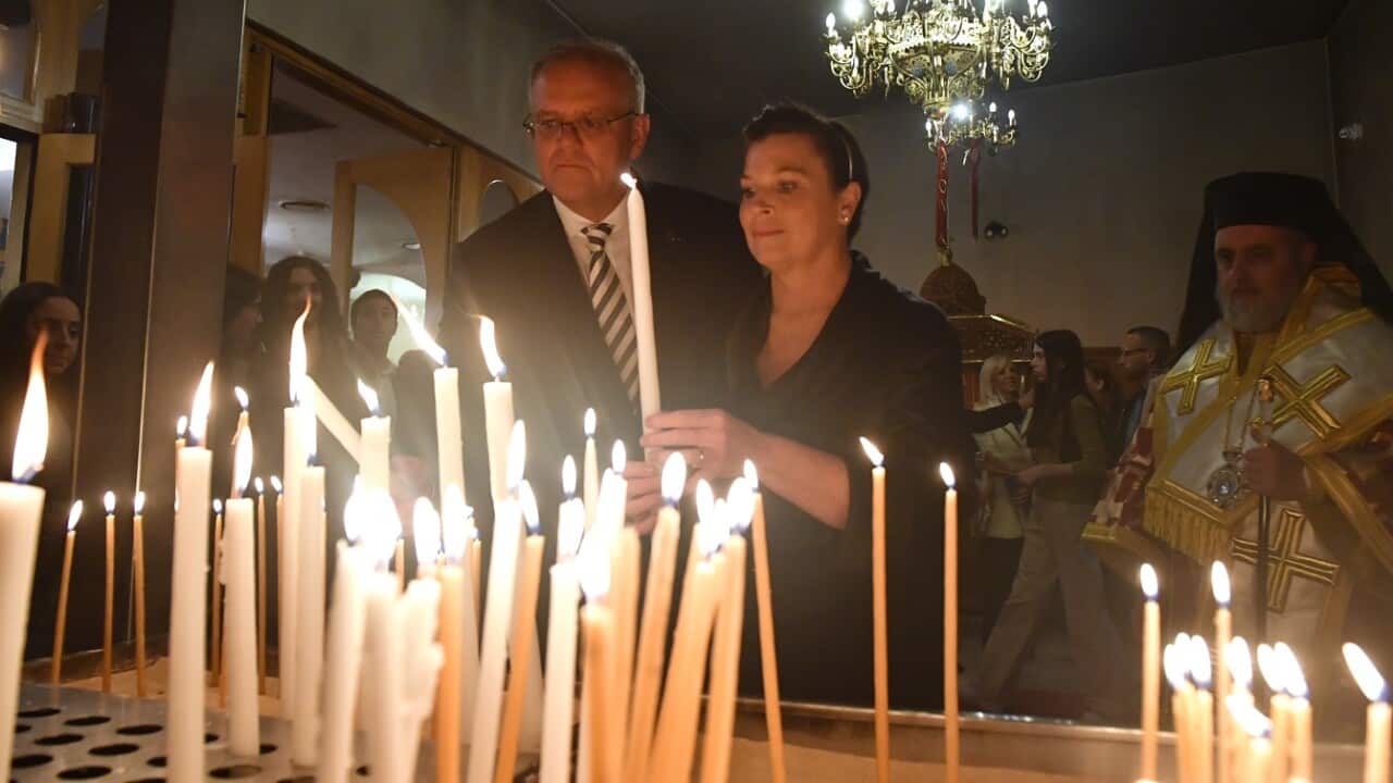 Prime Minister Scott Morrison light candles at Greek Orthodox Easter service on Day 14 of the 2022 federal election campaign,