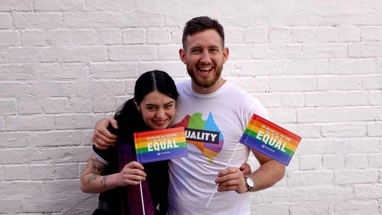 Staff from Heart Attack & Vine Bar in Melbourne, displaying the HRC's rainbow flag stickers.