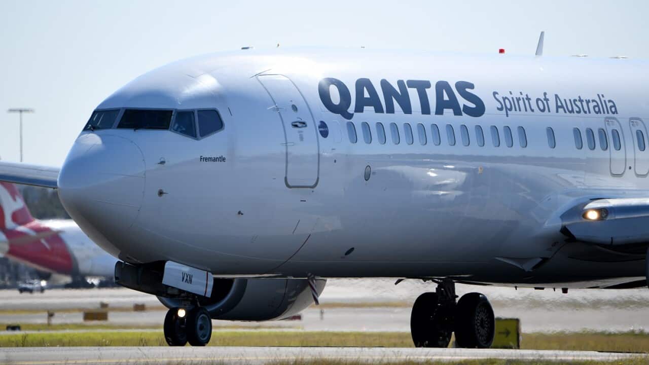 A white plane with QANTAS Spirit of Australia written on its side