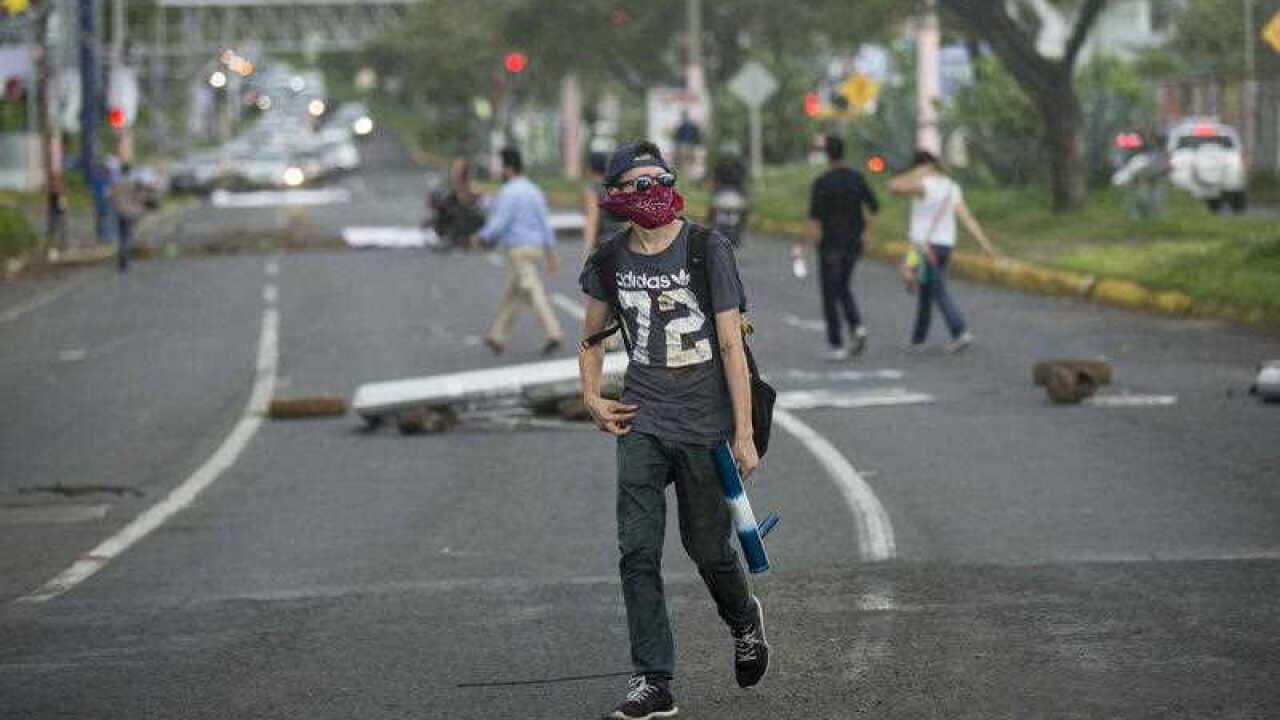 A young man holds a mortar spear during a protest in support of the city of Masaya in Managua, Nicaragua, 04 June 2018.