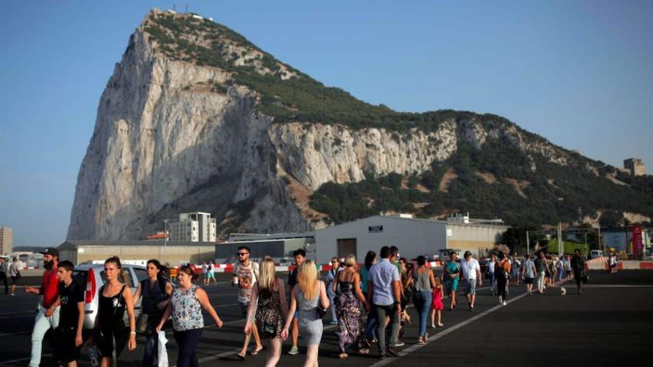 Pedestrians cross the tarmac at Gibraltar International Airport