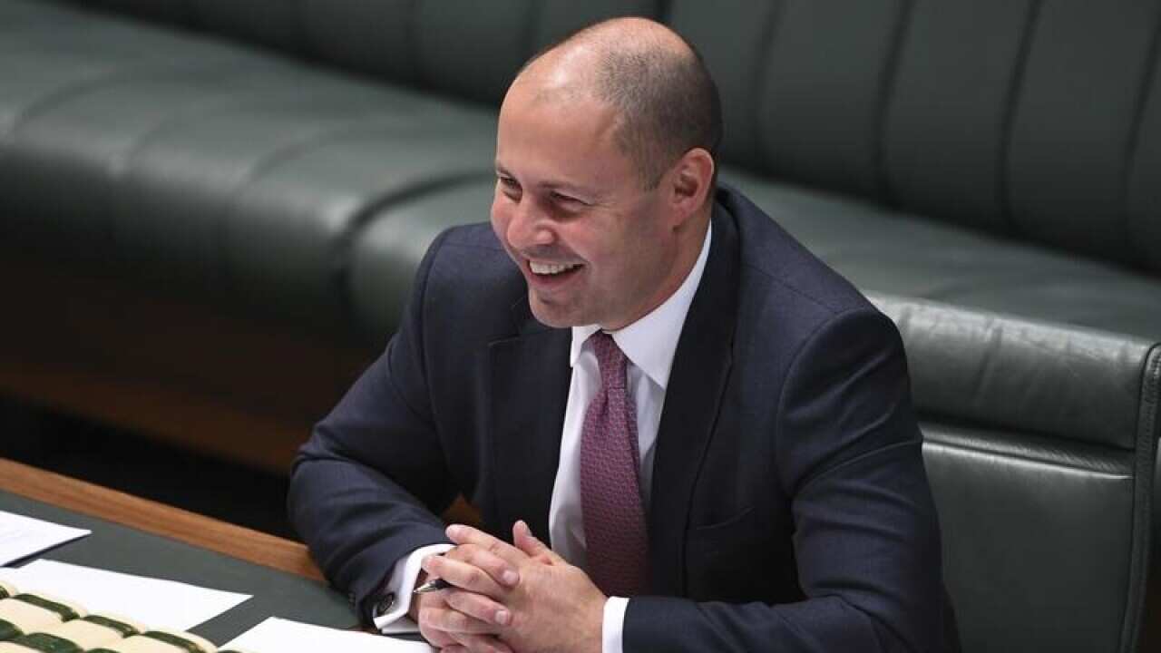 Josh Frydenberg laughs during a tax cuts debate in parliament.