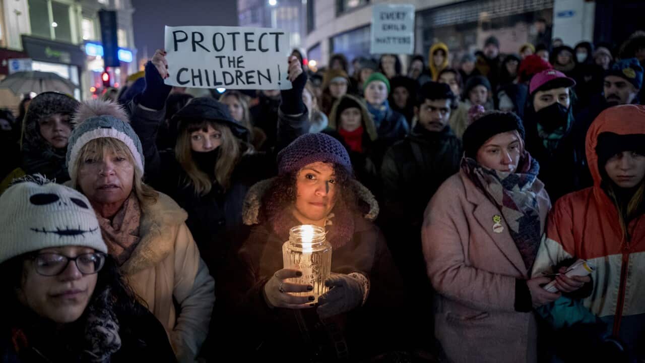 Protesters holding placards and candles campaign to protect asylum seeking children