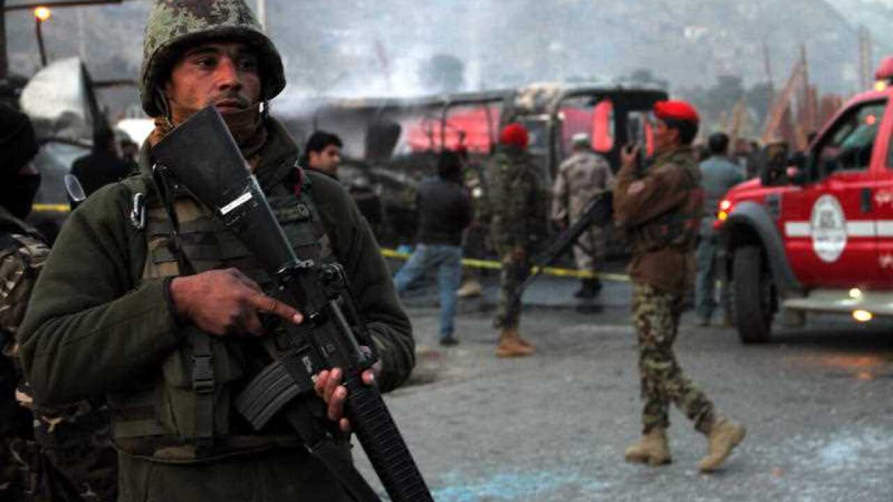Afghan security officials inspect the scene of a suicide bomb attack on a bus south of Afghanistan's capital Kabul on December, 13, 2014. (File: AAP)