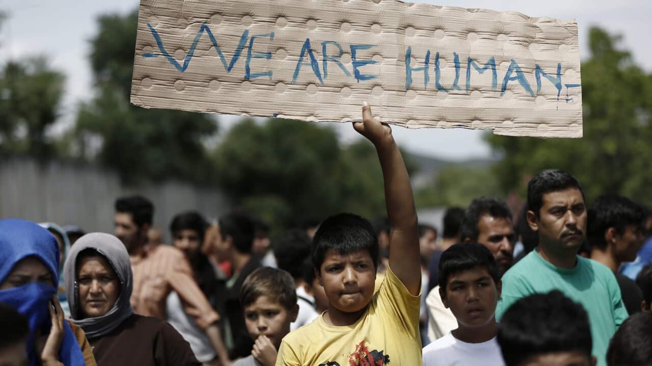 Afghan migrants take part in a protest.
