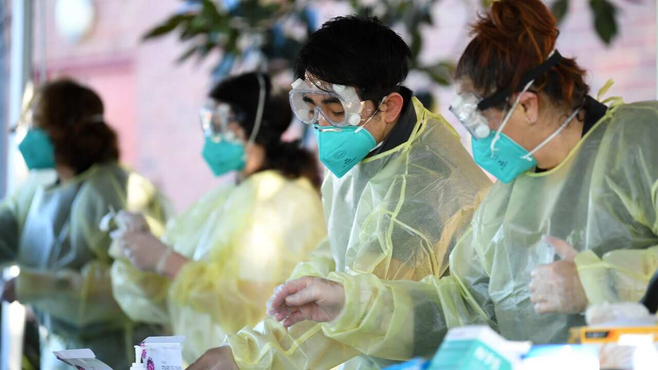 A file photo of healthcare workers administering COVID-19 Rapid Antigen tests on Campus at Firbank Grammar School in Brighton, Melbourne.