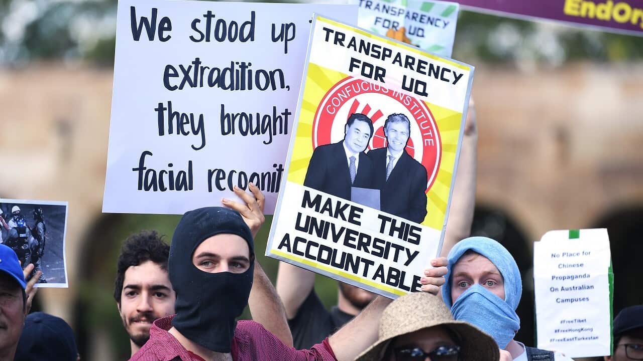 Students hold placards during a protest at the University of Queensland in Brisbane.