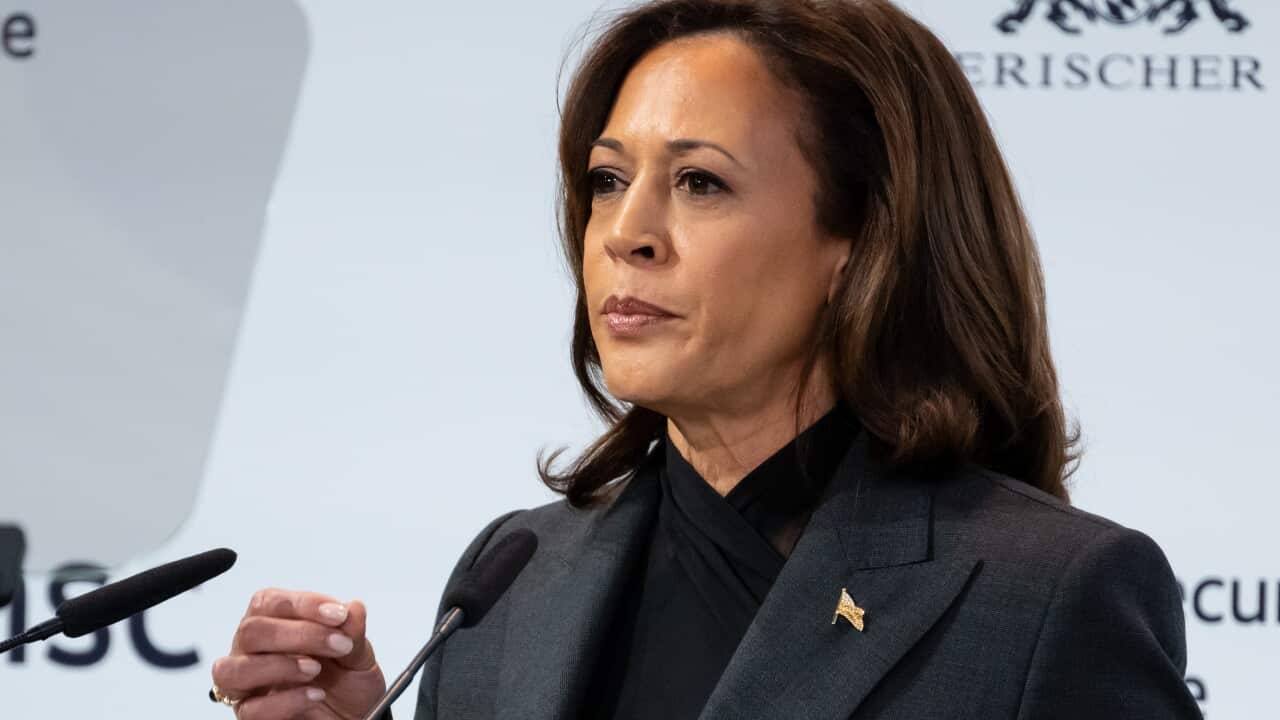 A woman speaks at a lecturn.