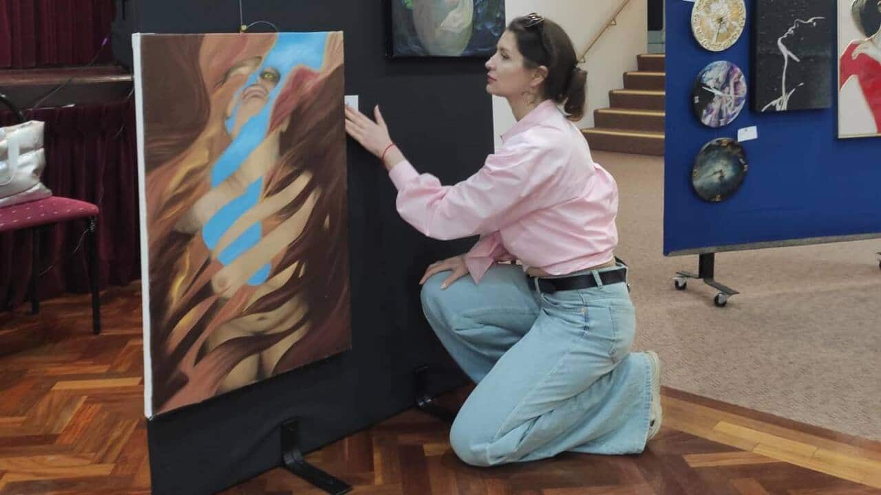 Ksenia Kirkbride with her works.jpg