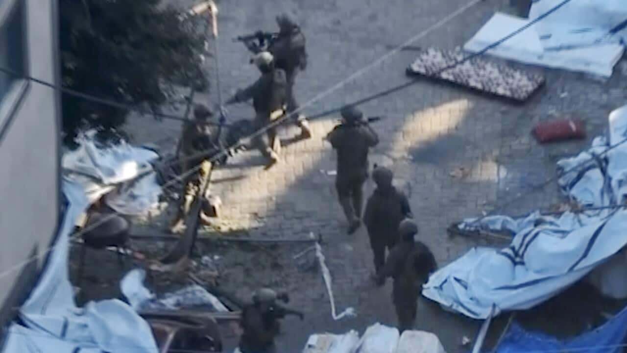 Israeli soldiers walk in the area of Al-Shifa hospital in Gaza City
